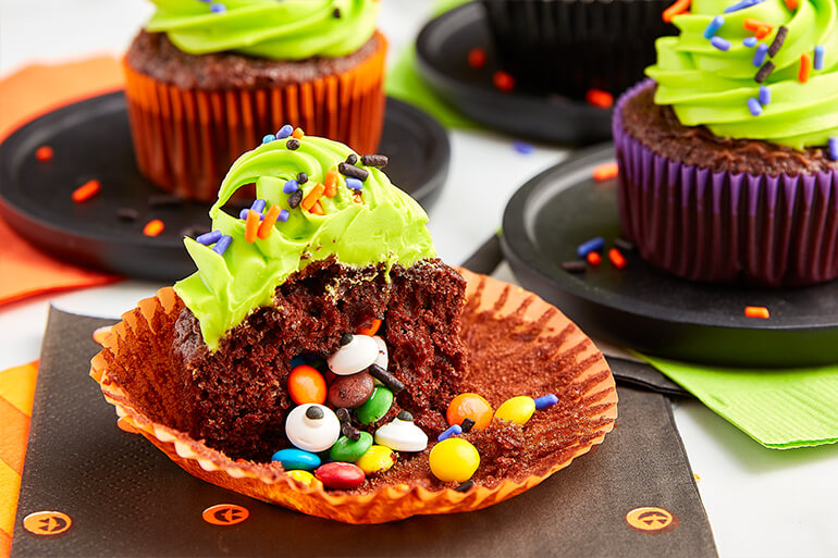 Chocolate cupcakes with green bitumen and candied chocolate filling