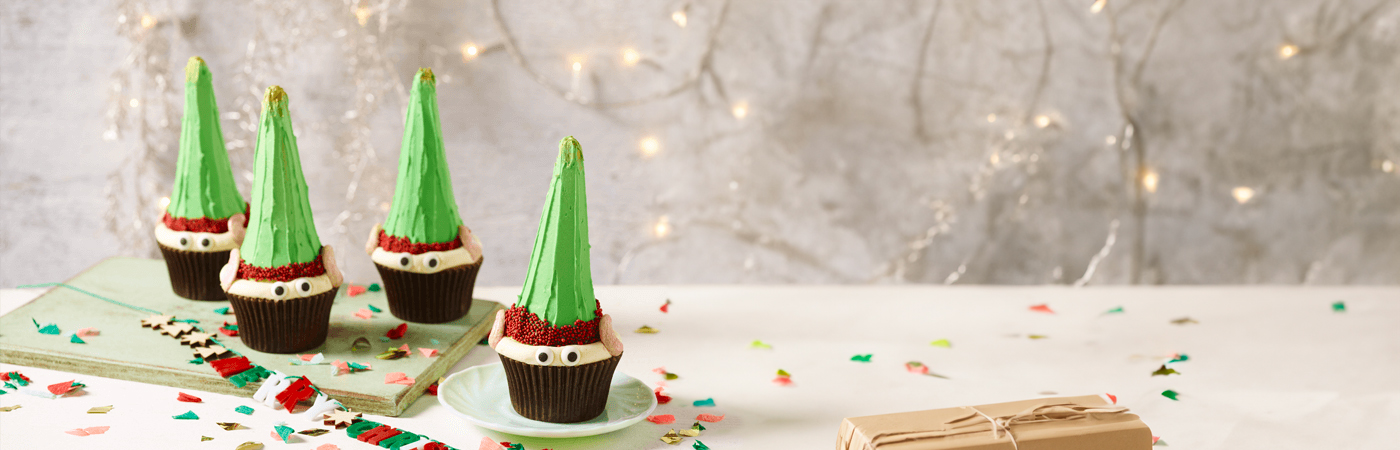Elf cupcakes served on decorative table