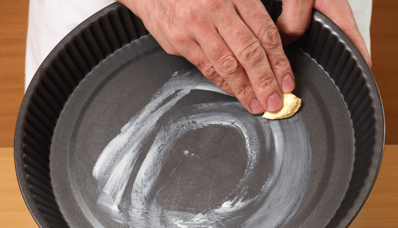 greasing cake pan with butter